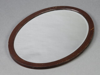 An oval bevelled plate wall mirror contained in a mahogany frame 51cm h x 66cm 