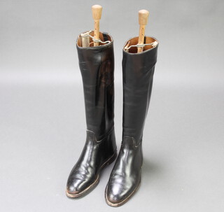 A pair of black leather riding boots complete with beech and metal sprung trees (signs of old but treated worm to the trees 
