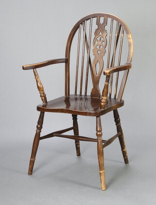 An elm wheel back Windsor carver chair, raised on turned supports with H framed stretcher 95cm h x 58cm w x 45cm d (seat 28cm x 30cm) 