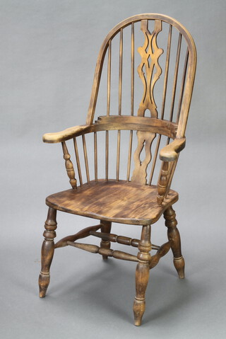 A 19th Century style beech framed Windsor stick back carver chair with solid seat, raised on turned supports with double H framed stretcher 120cm h x 64cm d x 36cm w (seat 30cm x 35cm, there is a split to the seat) 