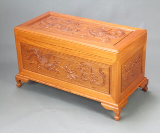 A Chinese carved camphor coffer, decorated a dragon and with fitted interior, raised on ogee bracket feet 59cm h x 100cm w x 50cm d 