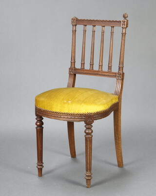 A Victorian carved walnut stick and rail back dining chair with over stuffed seat, raised on turned and fluted supports 85cm h x 38cm w x 40cm (seat 29cm x 25cm, 1 finial missing) 
