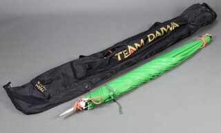 A Daiwa fabric fishing rod case containing a large fishing umbrella