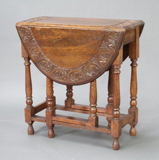 An oval drop flap gateleg tea table raised on turned and block supports 74cm h x 75cm x 35cm 
