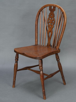 An elm wheel back chair with solid elm seat raised on turned supports, H framed stretcher 90cm h x 39cm w x 43cm d (seat 29cm x 29cm) 