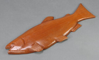 A carved wooden plaque in the form of a trout 22cm x 58cm 