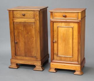 A near pair of 19th Century Continental fruitwood bedside cabinets fitted a drawer above cupboard enclosed by panelled doors, raised on ogee bracket feet 74cm h x 41cm w x 31cm d 