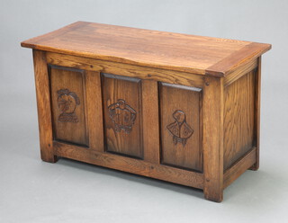 An oak coffer with hinged lid and carved panels to the front 52cm h x 93cm w x 41cm d 