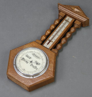 A Short & Mason aneroid barometer and thermometer contained in an oak stylised wheel case 
