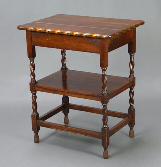 A 1930's oak 2 tier occasional table with pie crust edge, raised on spiral turned and block supports 72cm h x 60cm w x 44cm d (some damage to the top and sun bleaching) 