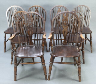 A set of 8 elm and beech wheel back dining chairs - 2 carvers 100cm h x 52cm w x 51cm d (seat 30cm x 33cm), 6 standard chairs 90cm h x 38cm w x 45cm d (seat 31cm x 29cm, one with broken wheel, some contact marks to the high points and a split to the hoop of both carver chairs)  