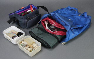 A blue fabric bag containing fishing floats etc and a blue haversack with landing net etc 