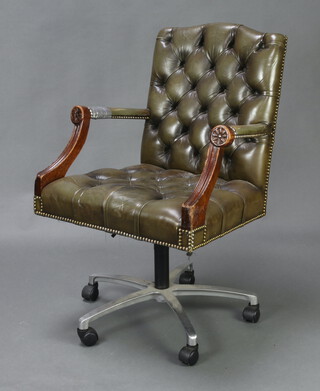 An office revolving armchair upholstered in green buttoned leather 96cm h x 64cm w x 55cm d (seat 39cm x 40cm, some damage to the leather) 