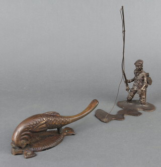 An aneroid barometer with silvered dial contained in an oak case (glass f), a bronzed figure of a fisherman 23cm x 12cm x 8cm, a metal nutcracker in the form of a fish 6cm x 17cm x 5cm 