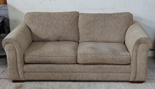 A two seat settee upholstered in oatmeal colour material 84cm h x 205cm w x 95cm d
(seat 151cm x 49cm) 