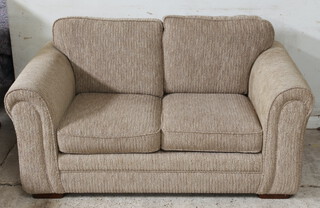 A two seat sofa upholstered in oatmeal colour material 80cm h x 163cm w x 95cm d (seat 111cm w x 49cm) together with a matching armchair 92cm h x 103cm w x 95cm d (seat 44cm x 42cm)  