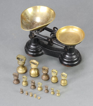 A pair of iron domestic pan scales with brass pan and 17 various weights 