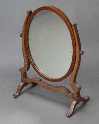 A 19th Century oval plate dressing table mirror contained in a mahogany swing frame 59cm x 24cm x 42cm (joints are loose) 