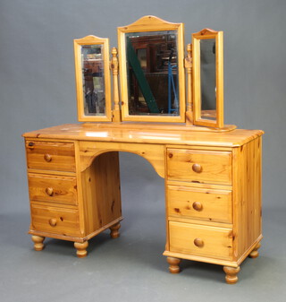 A pine dressing table with triple plate mirror and 6 short drawers 135cm h x 130cm w x 44cm d 