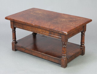 A rectangular oak 2 tier coffee table raised on turned and block supports 38cm x 76cm x 46cm (some water and contact marks to the top) 