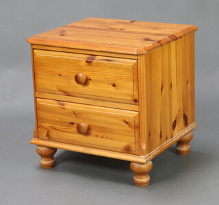 A pine bedside chest of 2 drawers with tore handles, raised on bun feet 51cm h x 50cm w x 45cm d 