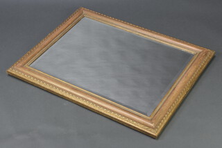 A rectangular bevelled plate wall mirror contained in a decorative gilt frame 76cm x 94cm 