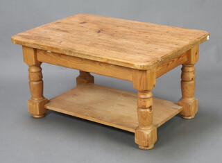 A rectangular pine 2 tier coffee table raised on turned supports 49cm h 91cm w x 62cm d (some ring marks to top) 