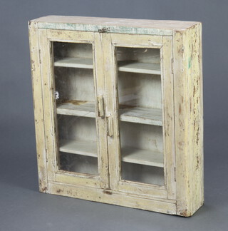 A white painted pine hanging cabinet, fitted shelves enclosed by glazed panelled doors 68cm h x 63cm w x 15cm d 