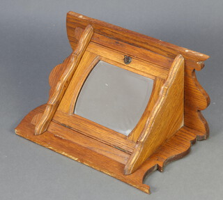 An Art Nouveau oak hanging corner cabinet enclosed by a bevelled mirror panelled door 56cm h x 29cm w 