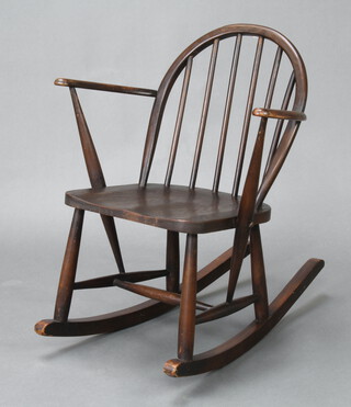 An Ercol utility dark elm stick and rail back rocking chair marked R182 72cm h x 61cm w x 74cm d