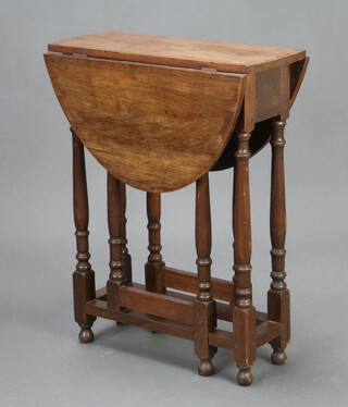 A light oak drop flap gateleg table raised on turned supports 70cm h x 56cm w x 23cm d 