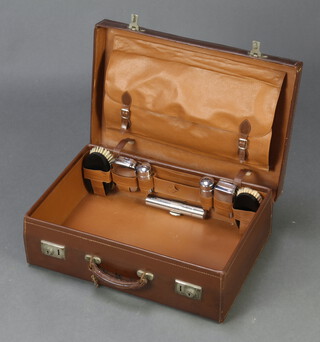 A leather vanity case, part fitted and with chrome mounts 15cm h x 50cm w x 34cm d 