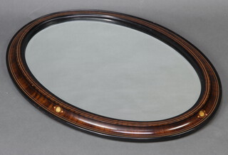 An Edwardian oval bevelled plate wall mirror contained in an inlaid mahogany frame 64cm x 90cm 