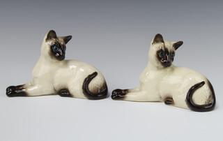 Two Royal Doulton figures of reclining Siamese cats no.1558 18cm 