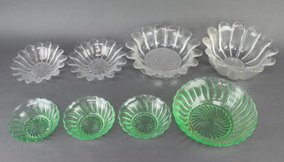 Four clear glass sunflower style glass bowls together with a pressed green glass bowl and 3 dishes 