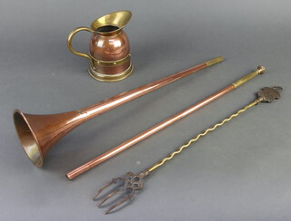 A copper coaching horn, jug and brass toasting fork 