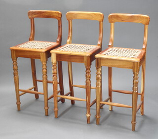 A set of 3 African hardwood bar back stools with woven hide seats, raised on turned supports 110cm h x 44cm w x 41cm d (seat 35cm x 30cm) 