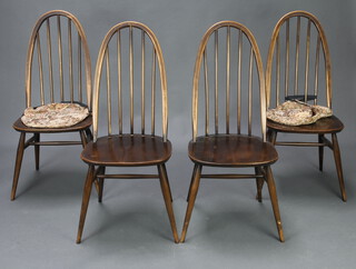 A set of four Ercol beech and elm stick and rail back chairs with solid seats raised on turned supports with H frame stretcher 97cm h x 42cm w x 40cmd, inside seat 30cm x 30cm (rubbing to high points and slight scratches)