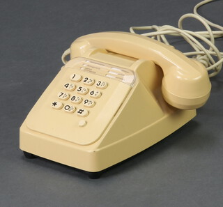 A French push button telephone in ivory with mother in law's earpiece