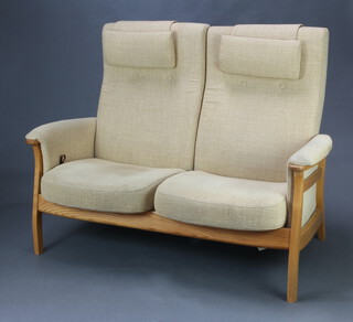 An Ercol elm framed two seat reclining sofa, upholstered in cream coloured material 130cm h x 138cm w x 60cm d, inside seat 110cm w x 42cm d (wear to the left hand arm)