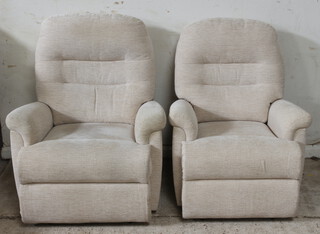 A pair of Parker Knoll reclining armchairs upholstered in cream coloured material 105cm h x 78cm w x 47cm d