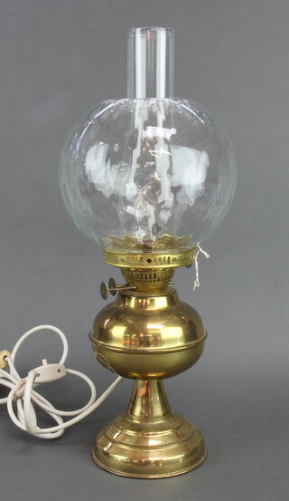 A brass oil lamp with clear glass shade and chimney, converted to electricity 36cm