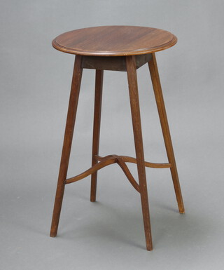 An Edwardian circular mahogany occasional table raised on outswept supports with X framed stretcher 79cm h x 43cm diam. 