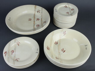 A Poole pottery bamboo dinner service comprising 19 small plates, 5 medium plates, 6 shallow bowls and 4 large shallow bowls