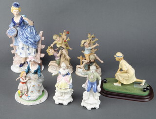 A pair of biscuit porcelain figures of children climbing trees and 5 other figures