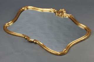 A Rococo style shaped plate wall mirror contained in a decorative gilt frame 77cm x 102cm
