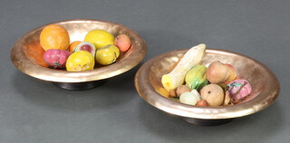 Two pressed and gilt metal bowls containing a collection of various artificial fruit 
