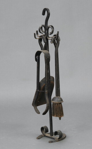 A wrought iron 4 piece fireside companion set, comprising poker, shovel, brush and tongs 62cm h