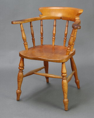 An elm and beech smokers bow chair raised on turned legs with H frame stretcher 91cm x 66cm w x 46cm d
