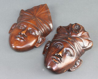A pair of Burmese carved hardwood masks